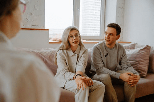 a couple sitting on a sofa