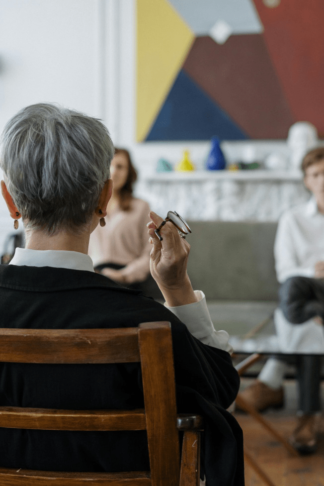 A couple sitting with a therapist during a couples therapy session