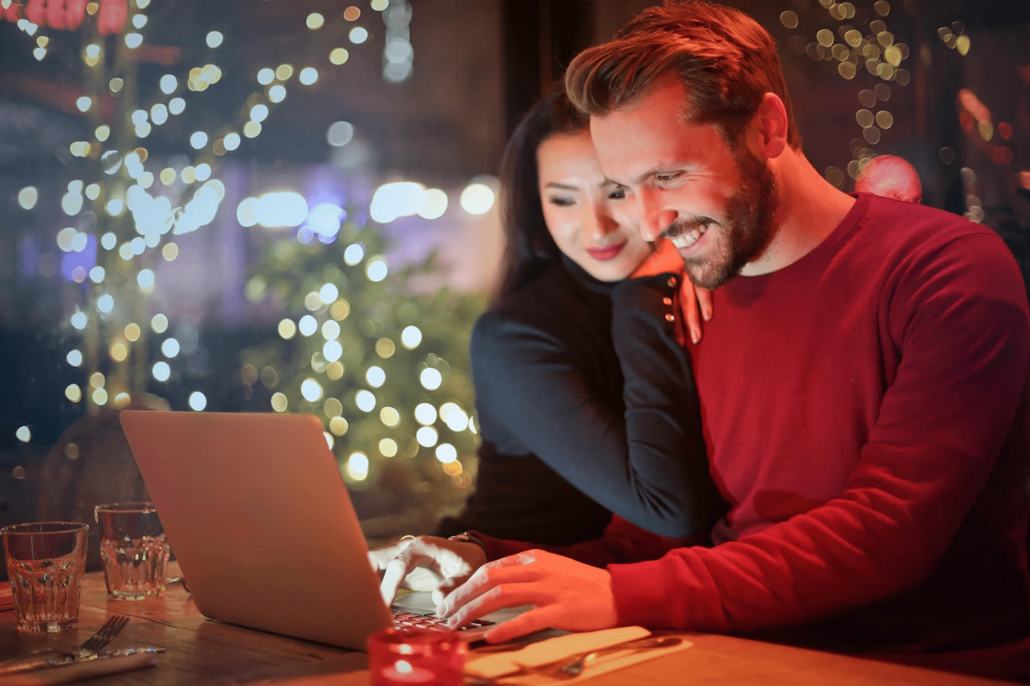 A happy couple looking at a laptop screen